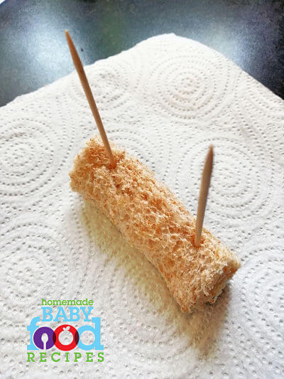 Making teething biscuits by holding rolled bread together with toothpicks