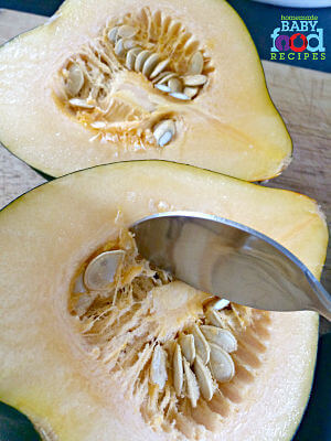 Scooping seeds from acorn squash