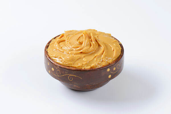 A bowl of peanut butter. Peanuts add flavour and protein to baby's oatmeal