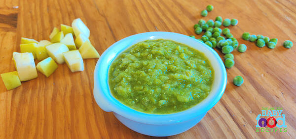 A bowl of pea and apple puree, with chopped apple and frozen peas