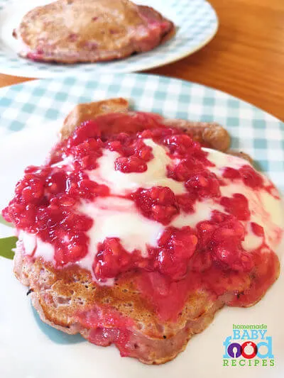 Rasberry pancakes topped with raspberry puree and natural yogurt