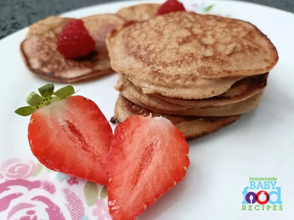 Pancakes for baby with fresh strawberries